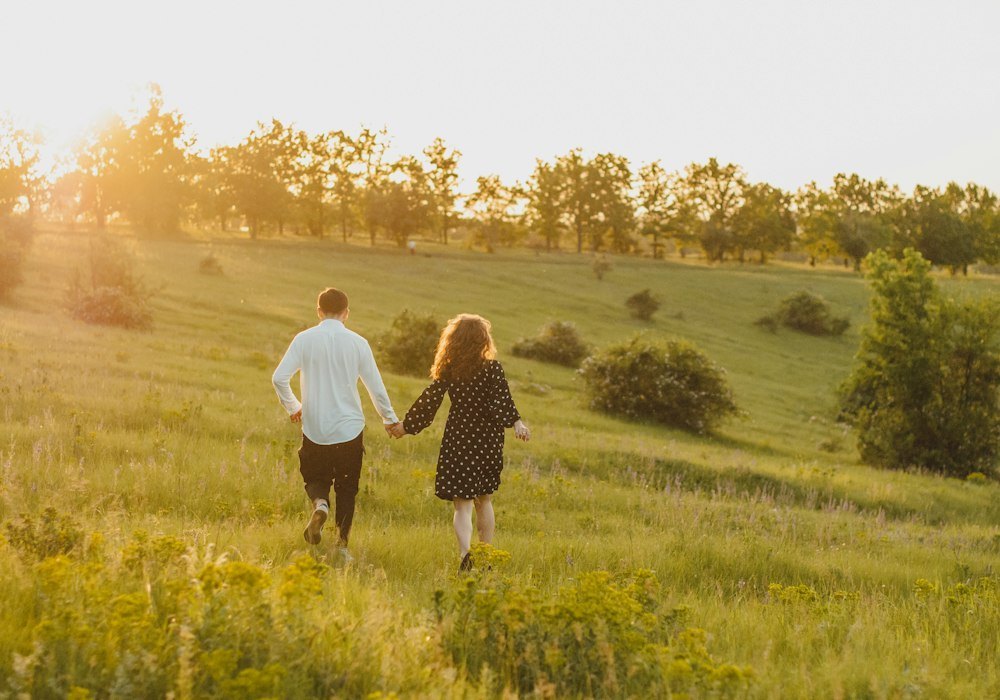 Couple walking through a sunny meadow